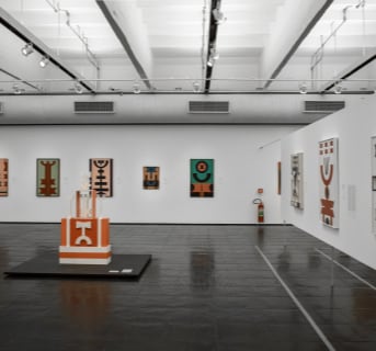 Image of art gallery with many abstract paintings